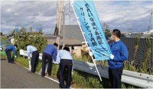 「きれいなまち美南区クルーンアップ月間」ののぼり旗を掲げながら道端のゴミ拾いをしている人たちの写真